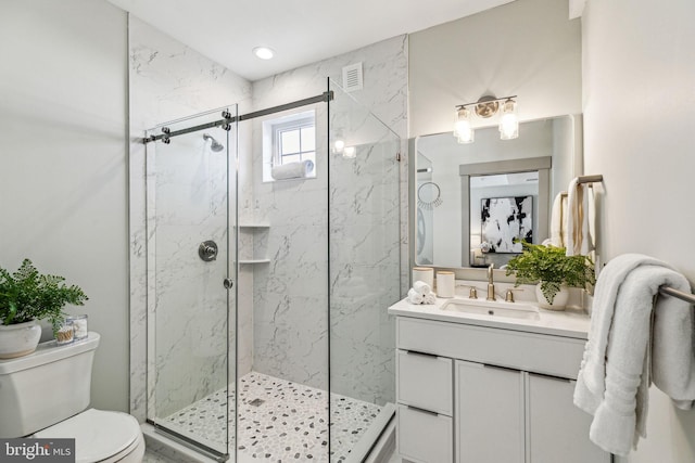 bathroom with a marble finish shower, toilet, and visible vents