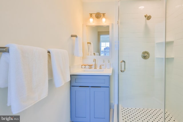 bathroom featuring a shower stall and vanity