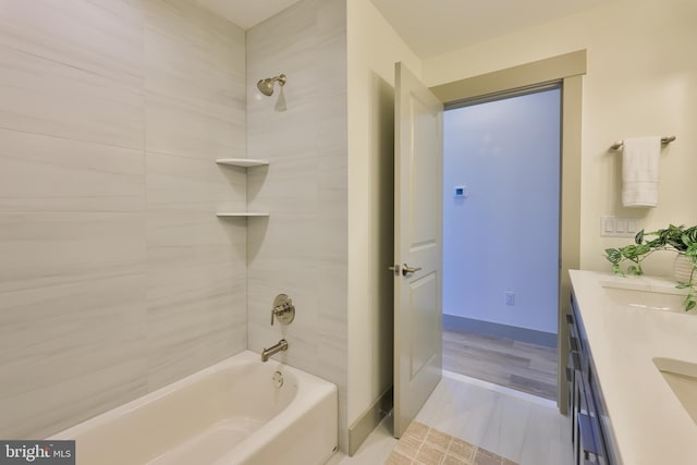 bathroom featuring shower / tub combination, double vanity, baseboards, and a sink