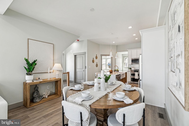 dining area with recessed lighting, visible vents, baseboards, and wood finished floors