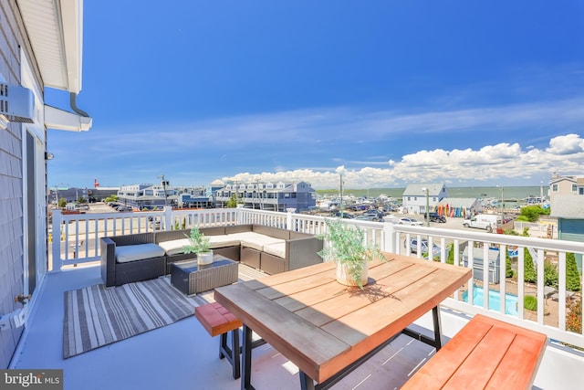 wooden deck with outdoor dining area and an outdoor hangout area