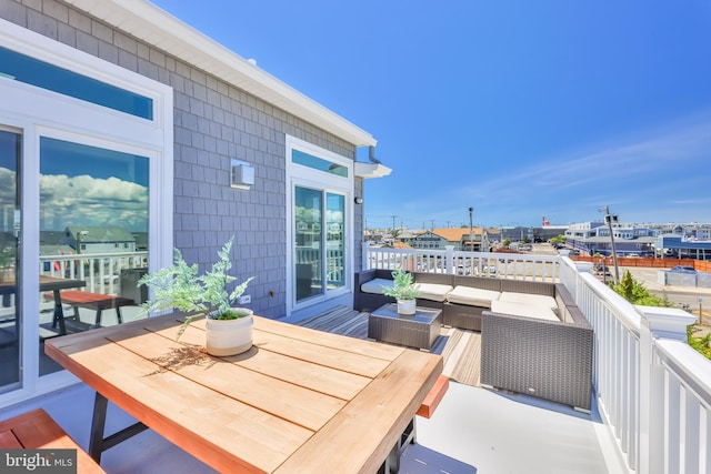 balcony with outdoor lounge area and outdoor dining area