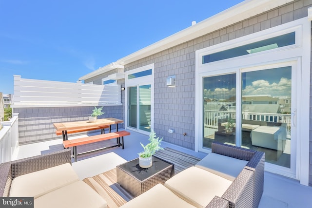 view of patio featuring an outdoor hangout area and a balcony