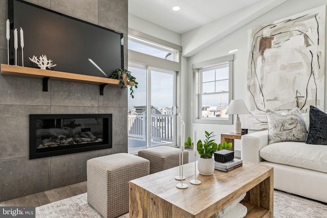 living area featuring a fireplace, recessed lighting, and wood finished floors