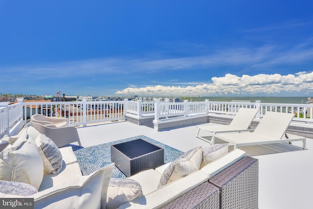 view of patio featuring an outdoor living space and a water view