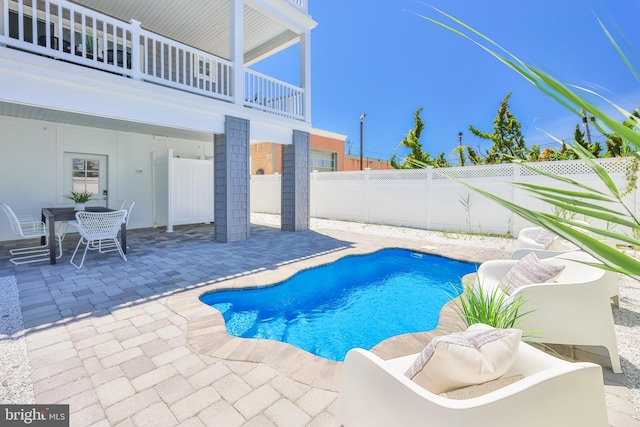 view of pool with outdoor dining space, a patio area, a fenced in pool, and a fenced backyard