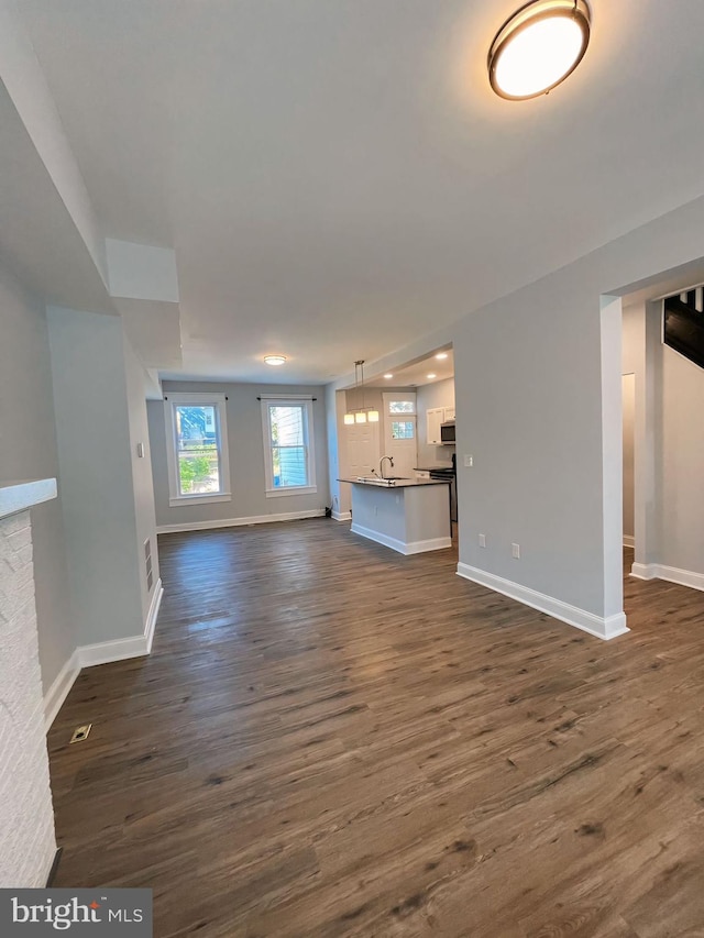 unfurnished living room with dark hardwood / wood-style floors