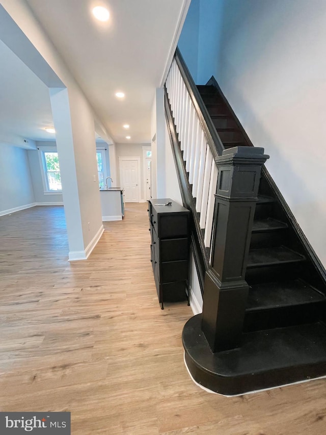 stairs featuring wood-type flooring