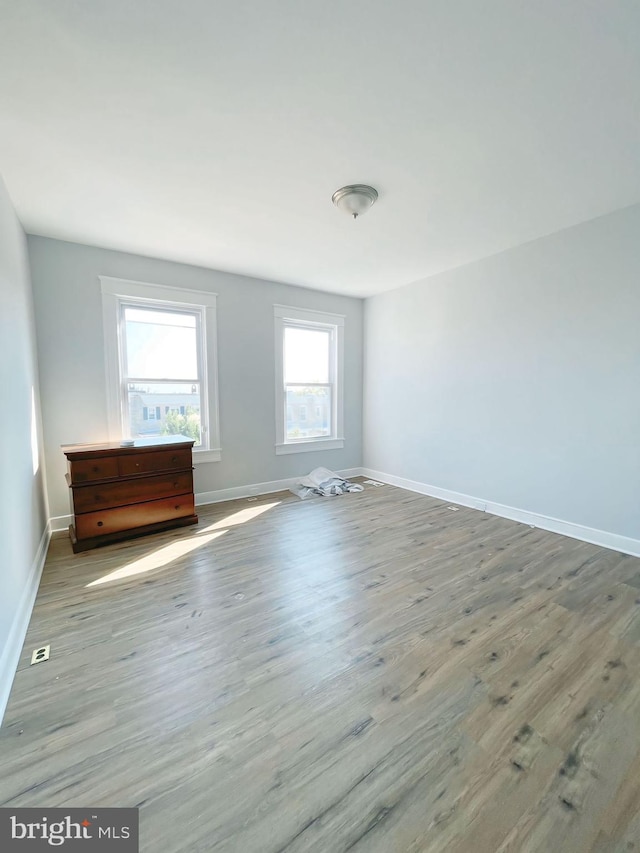 spare room with light hardwood / wood-style floors