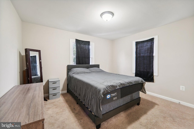 bedroom with light colored carpet