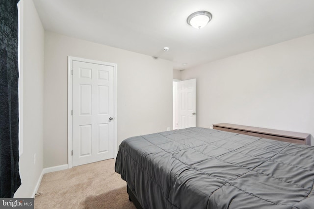 bedroom featuring light colored carpet