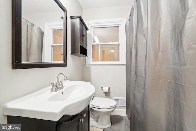 bathroom featuring vanity, toilet, and a shower with shower curtain