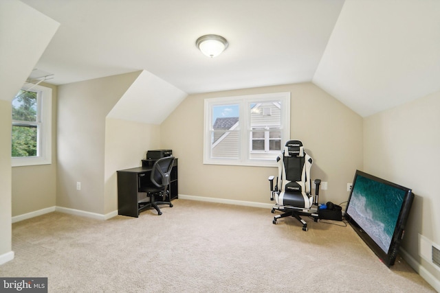 office with vaulted ceiling and light carpet