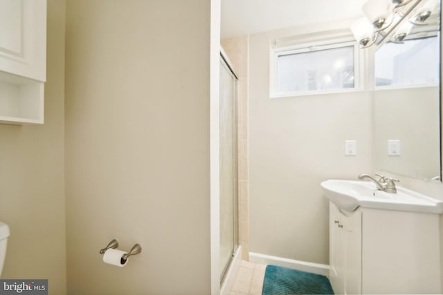 bathroom featuring vanity, toilet, a shower with shower door, and tile patterned flooring