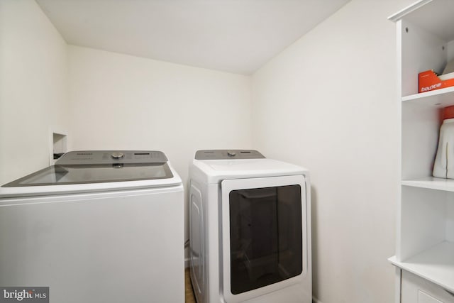 laundry area with independent washer and dryer