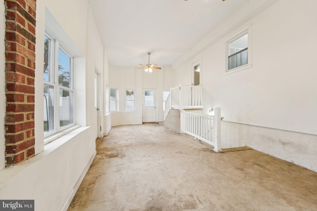 interior space featuring ceiling fan and plenty of natural light