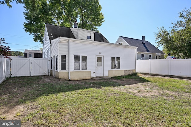 back of house with a lawn