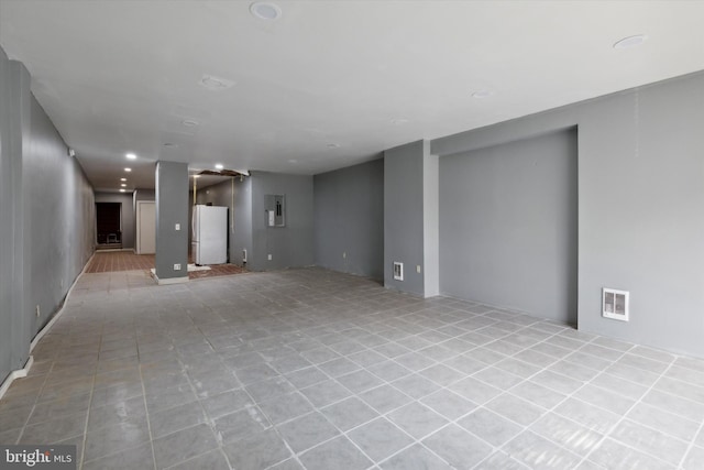 interior space with electric panel and light tile patterned floors