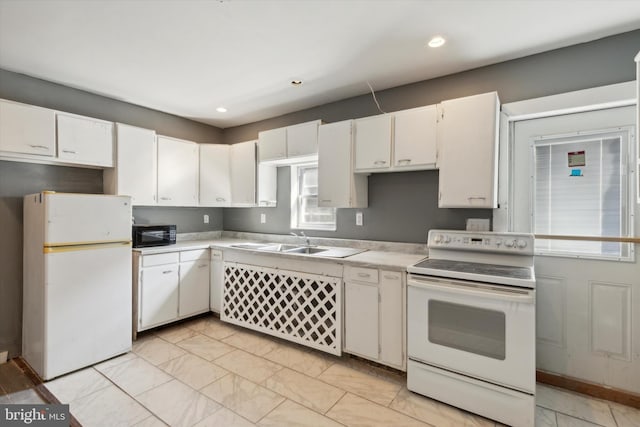 kitchen featuring white cabinets, white appliances, and sink