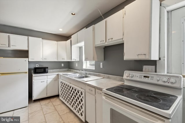 kitchen featuring white appliances, white cabinetry, and sink