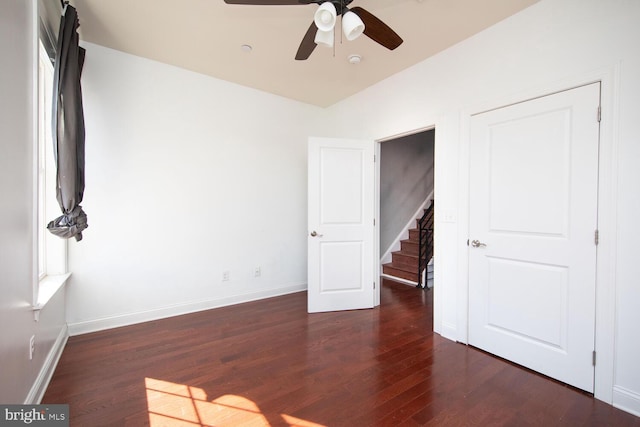 unfurnished bedroom featuring dark hardwood / wood-style floors and ceiling fan