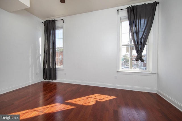 spare room with ceiling fan, dark hardwood / wood-style floors, and plenty of natural light