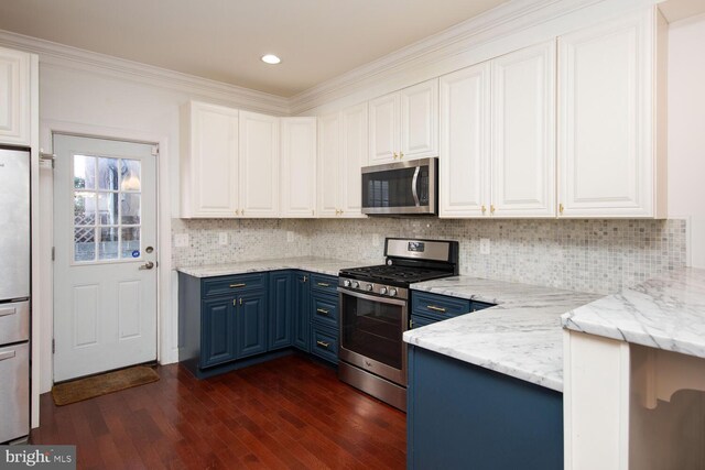 kitchen with dark wood-type flooring, sink, white cabinets, appliances with stainless steel finishes, and blue cabinetry