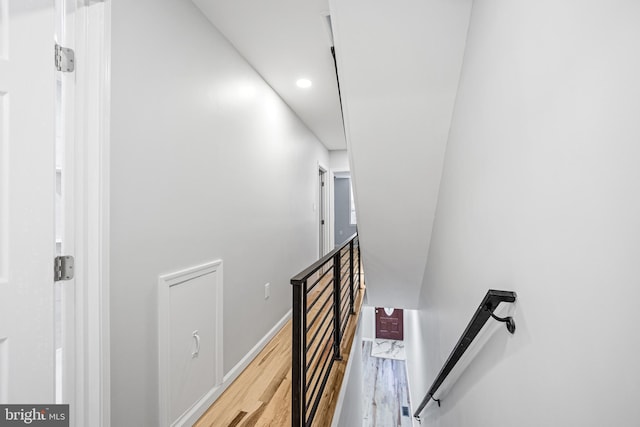 staircase with hardwood / wood-style floors