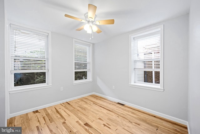 spare room with ceiling fan and wood-type flooring