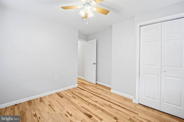 unfurnished bedroom with a closet, light hardwood / wood-style floors, and ceiling fan