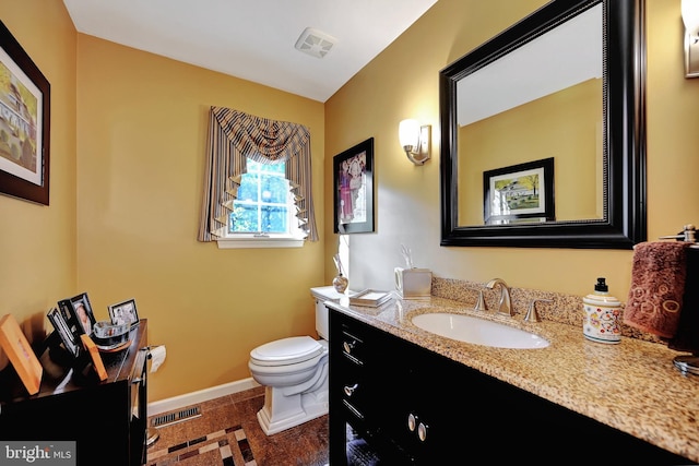 bathroom with vanity, toilet, and tile patterned floors