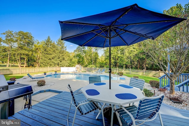 wooden deck featuring a fenced in pool