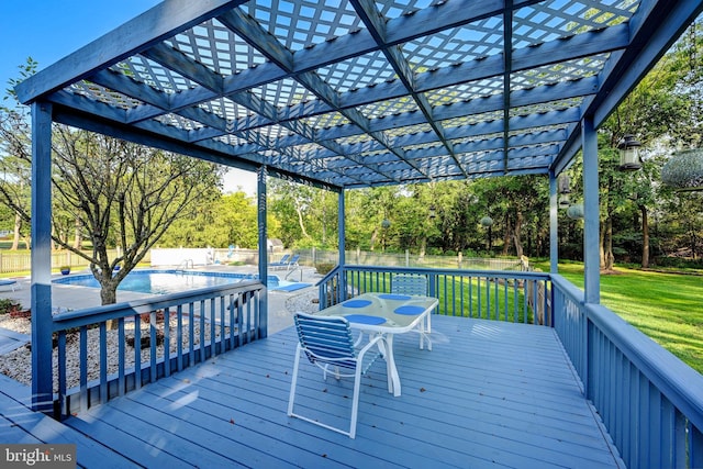 wooden terrace featuring a lawn and a pergola