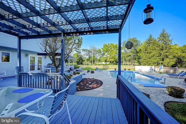 deck featuring a pergola, a fenced in pool, a patio, and french doors