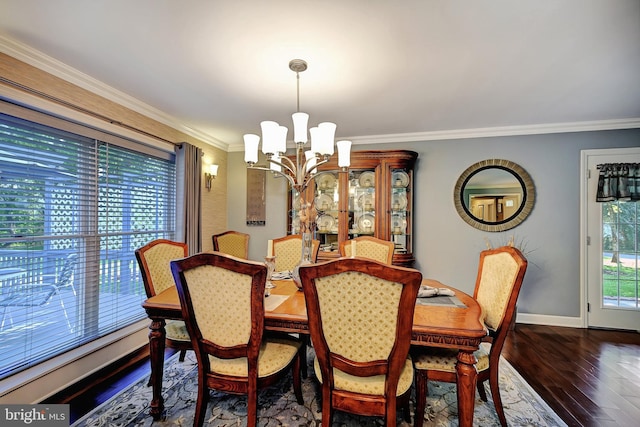 dining area with crown molding, dark hardwood / wood-style floors, and a chandelier