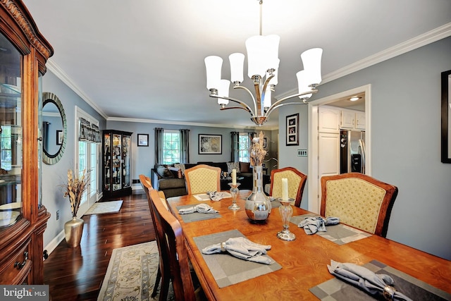 dining space featuring ornamental molding, a notable chandelier, and dark hardwood / wood-style floors