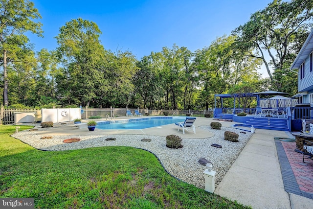 view of swimming pool with a yard, a fire pit, a gazebo, a patio area, and a deck