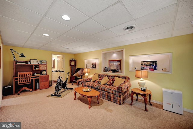 carpeted living room with a paneled ceiling