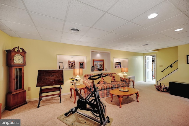 workout area featuring a drop ceiling and light colored carpet