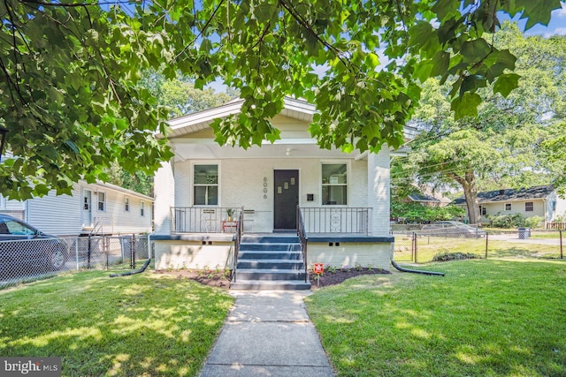 bungalow featuring a front yard and covered porch