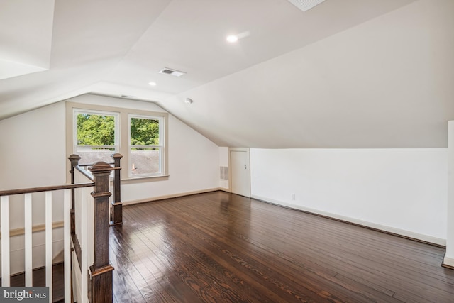 bonus room featuring lofted ceiling and dark hardwood / wood-style flooring