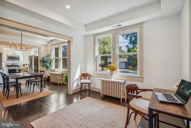 office space with radiator, dark hardwood / wood-style floors, and a notable chandelier