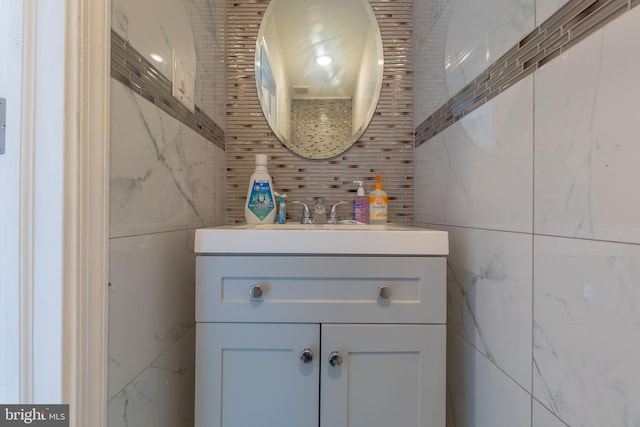 bathroom with vanity and tile walls