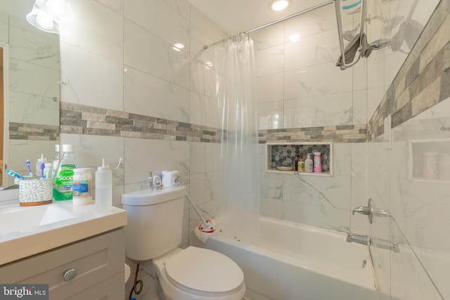 full bathroom with vanity, shower / bath combo, toilet, and tile walls