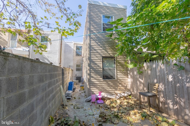 view of side of home with central AC