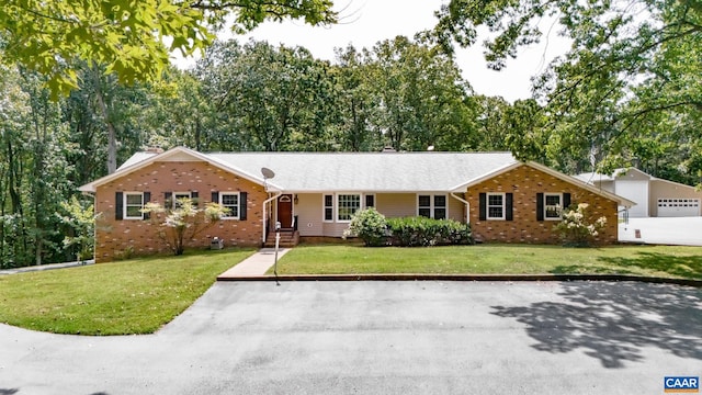 single story home with a front yard and brick siding