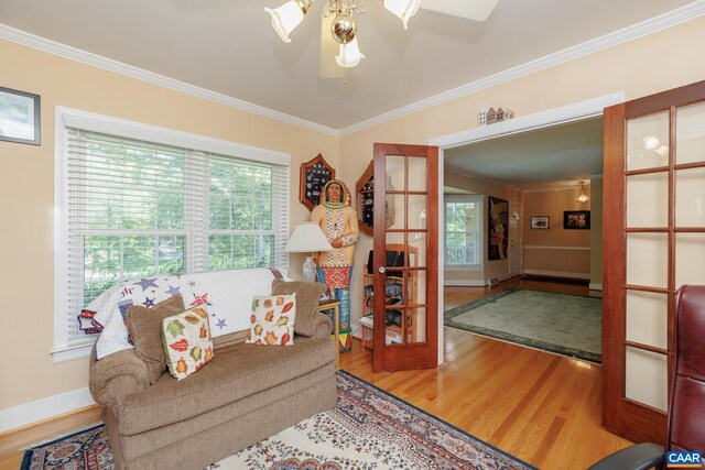 living room featuring a wealth of natural light, light hardwood / wood-style flooring, and ceiling fan