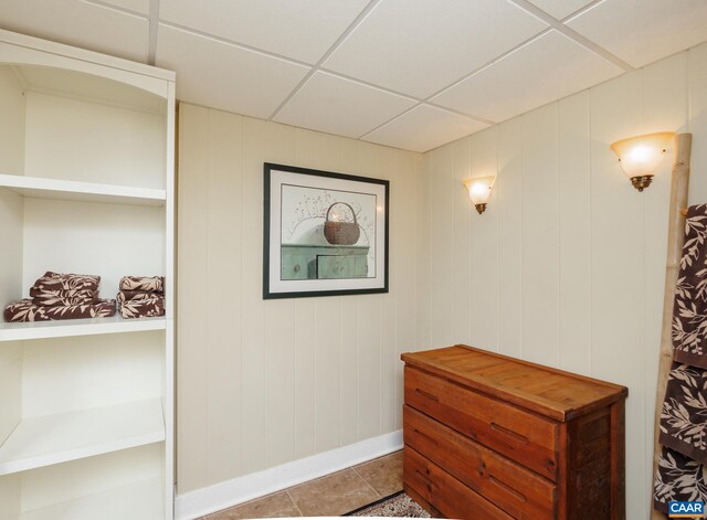 interior space with a paneled ceiling