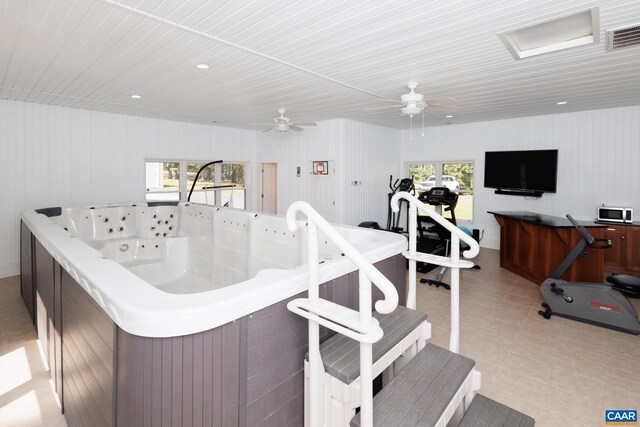 interior space featuring plenty of natural light, light tile patterned flooring, and ceiling fan