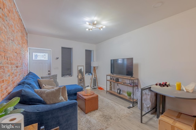 living room with a notable chandelier and light wood-type flooring